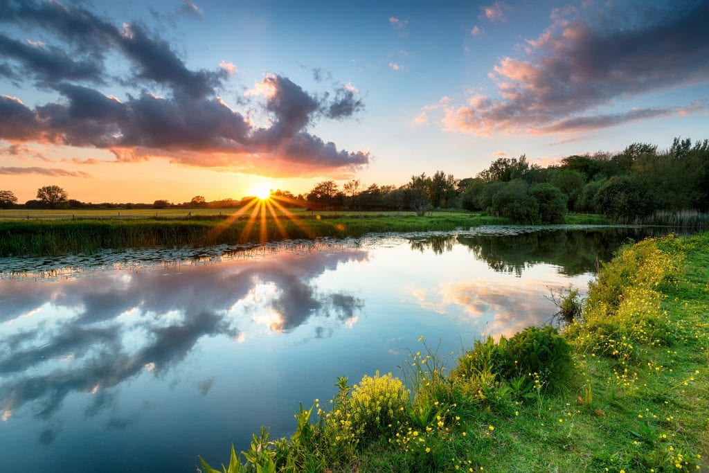 The sun sets over the River Stour, one of the best river walks in Dorset