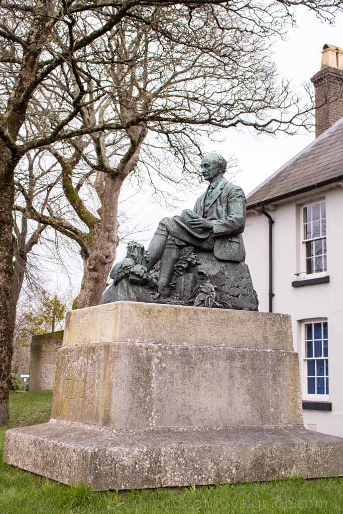 bronze statue of a man on a rectangular stone plinth