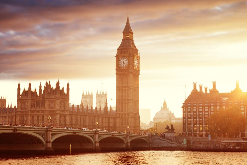 Big Ben and Westminster at sunset with the river in front and orange sky overhead, London, UK. best day trips from dorset. 