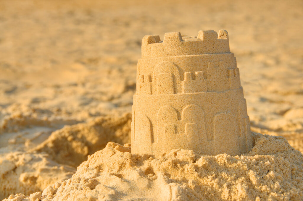 Close up of a sandcastle on the beach. Best dorset beaches for families. 