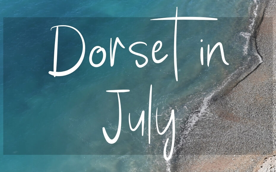 Dorset in July: written in white over an aerial photo of the sea on a sunny day