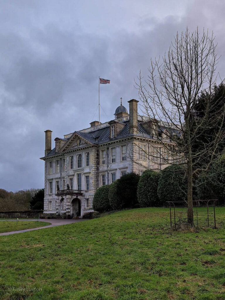 Large stately home with a lawn and grey sky | Kingston Lacy Dorset in February