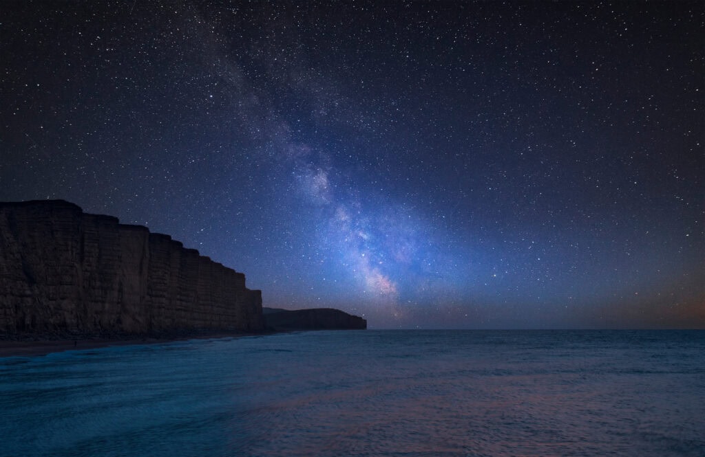 Milky Way over landscape of long exposure of West Bay | best time to visit dorset