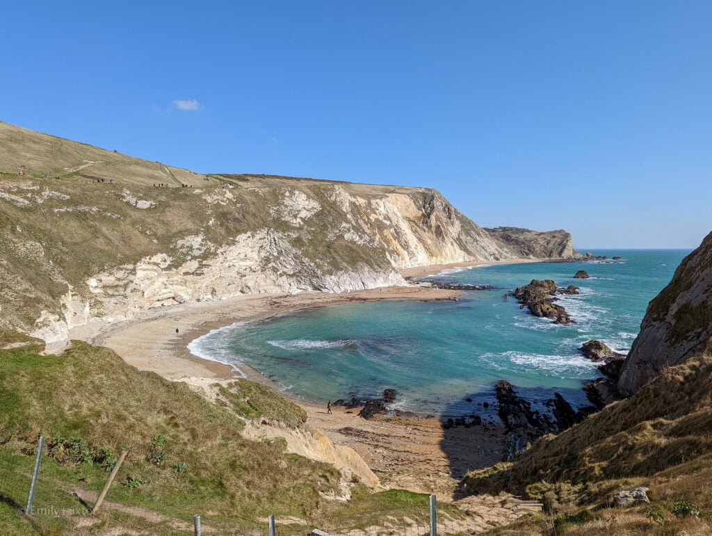 Small cove with turquoise water and rocky headland | Dorset in March